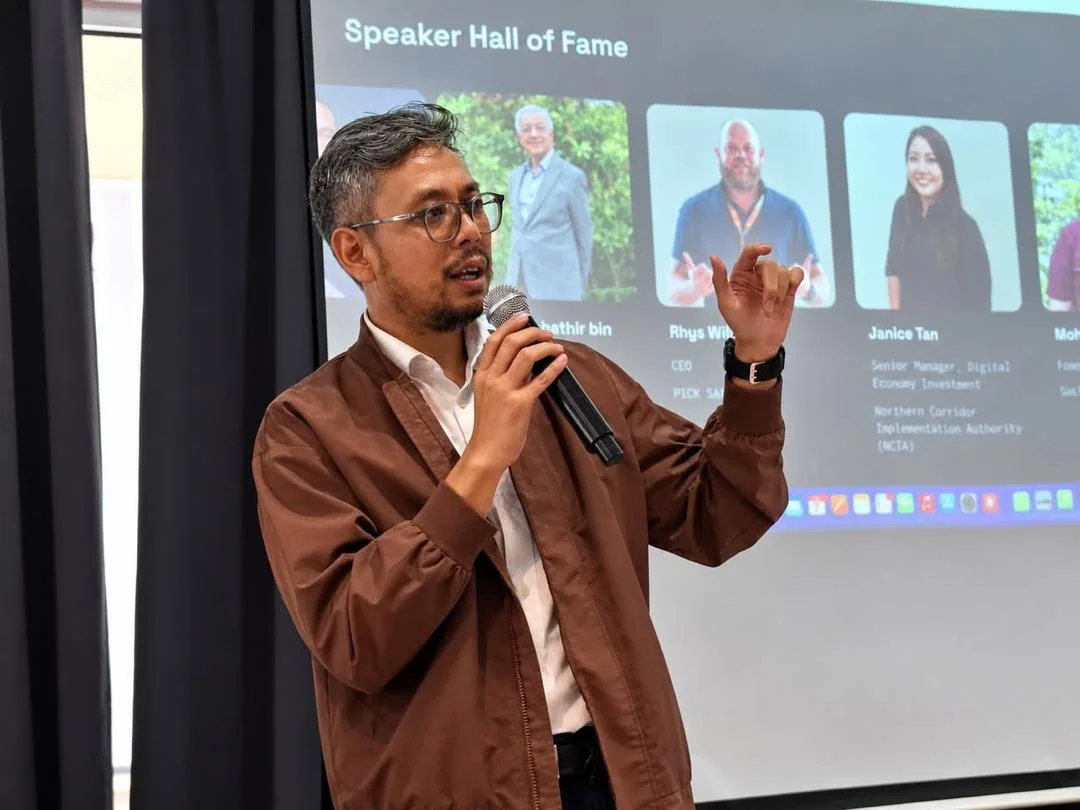 Ezri speaking into a microphone at a technology event