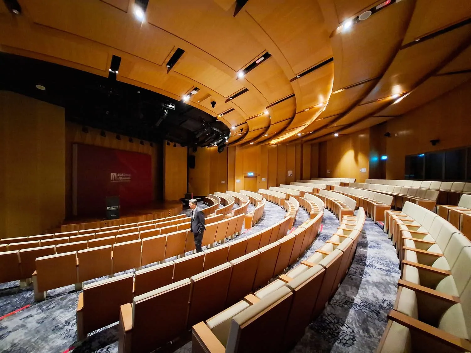 Ezri inside a large auditorium ahead of an event